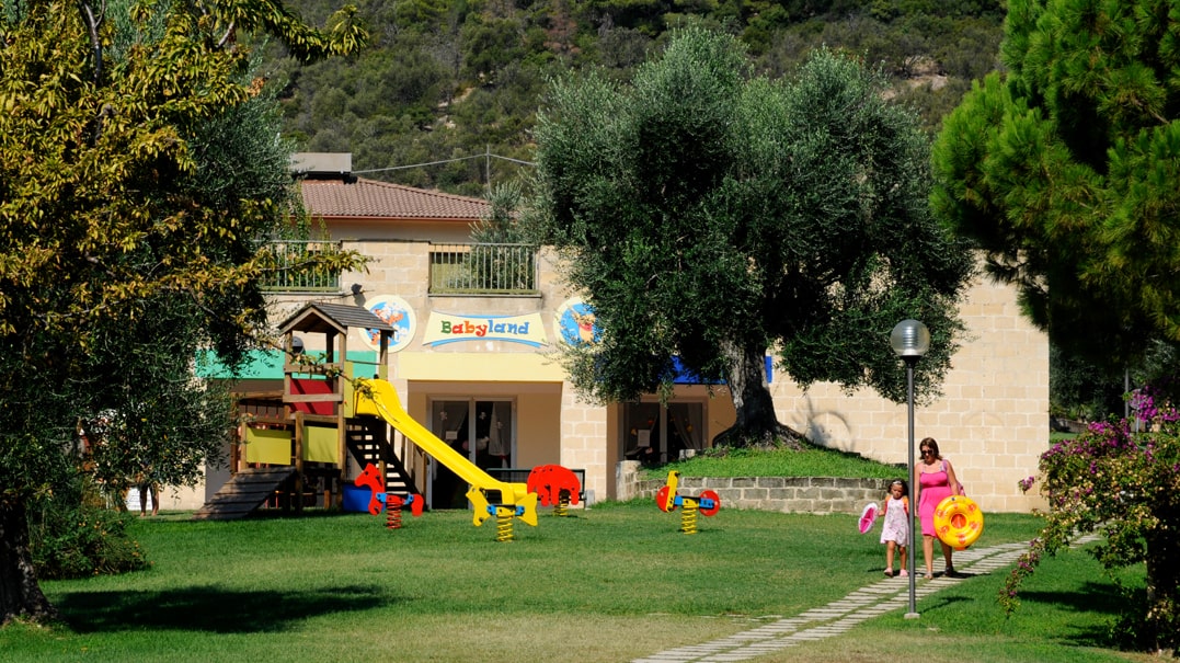 casetta in legno e scivolo nel parco giochi per bambini